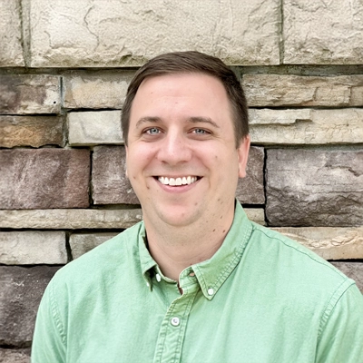 Dr. Andrew Green smiling in a green shirt.
