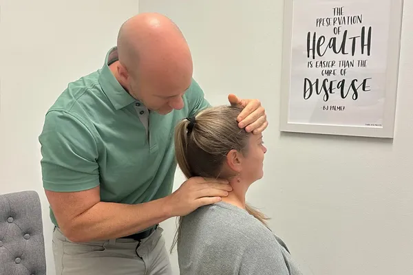 Chiropractor Clemmons NC Jason Barker Adjusting Patient's Neck Dr. Jason Barker adjusting a patient's neck.