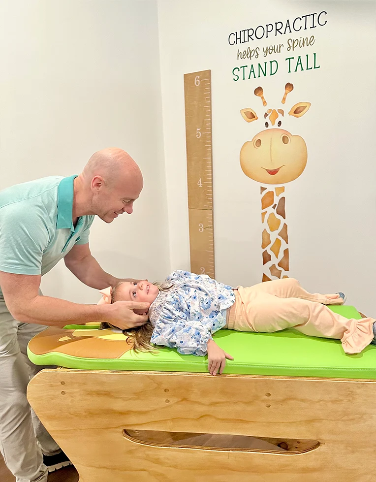 Chiropractor Jason Barker With A Pediatric Patient
