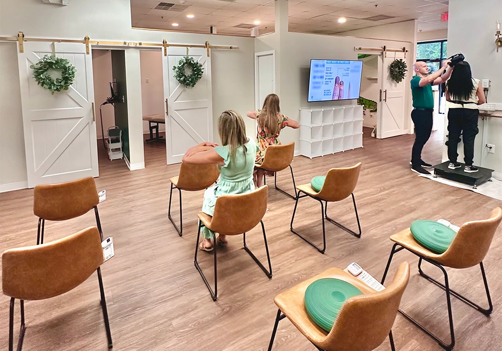 Jason Barker With Patients In Seating Area HP Mobile