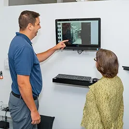 Chiropractor Clemmons NC Andrew Green What To Expect Dr. Andrew Green going over a patients X-rays.