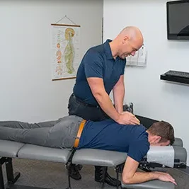 Chiropractor Clemmons NC Jason Barker Second Visit Dr. Jason Barker adjusting a patients upper back.